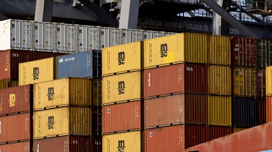 Bank of Japan holds rates, lowers growth forecasts