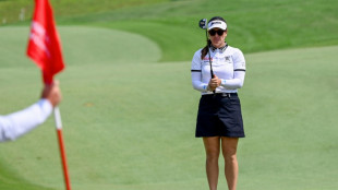 Green clinches Singapore title with help from caddie husband